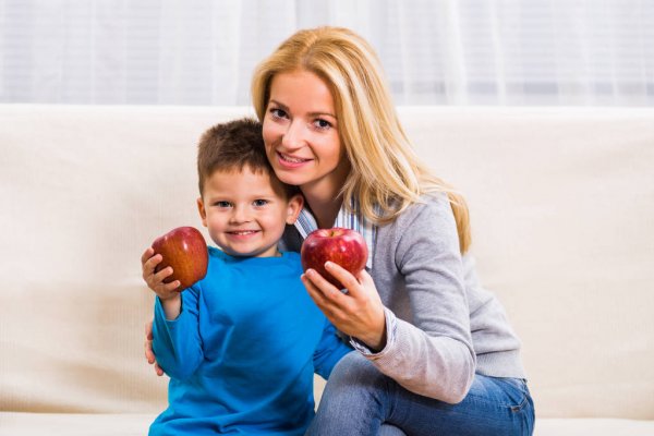 depositphotos 129313760 stock photo mother and son eating apple